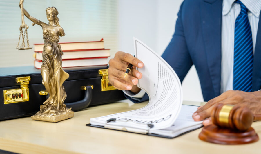 A male Asian lawyer in a formal suit handles contracts, agreemen Male Asian lawyer in formal suit handles contracts, agreements, legal obligations, rights liberties